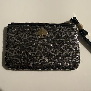 KATE SPADE: Black and silver sequined wristlet with bow zipper